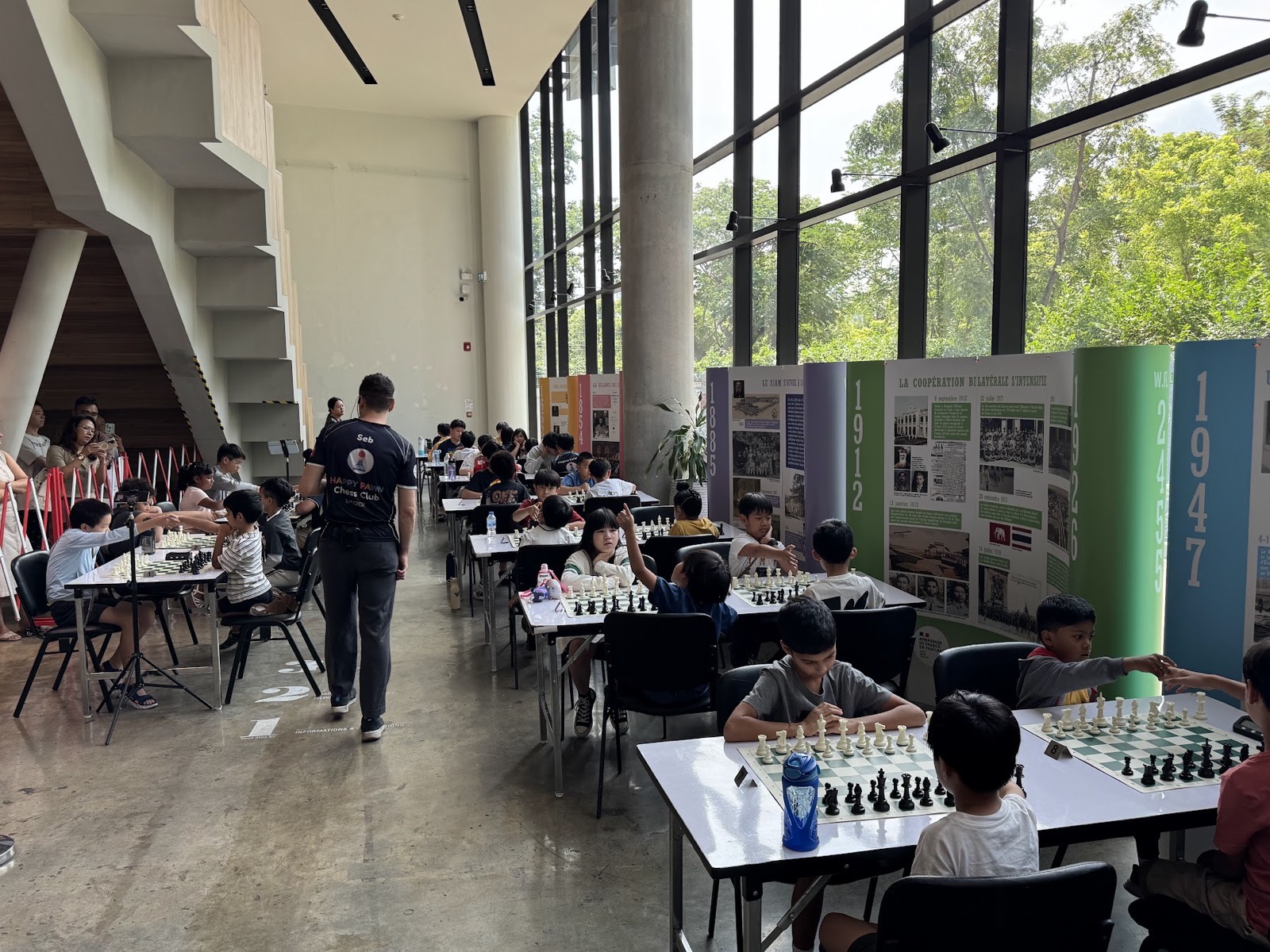 Wide view of Happy Pawn tournament hall with many players